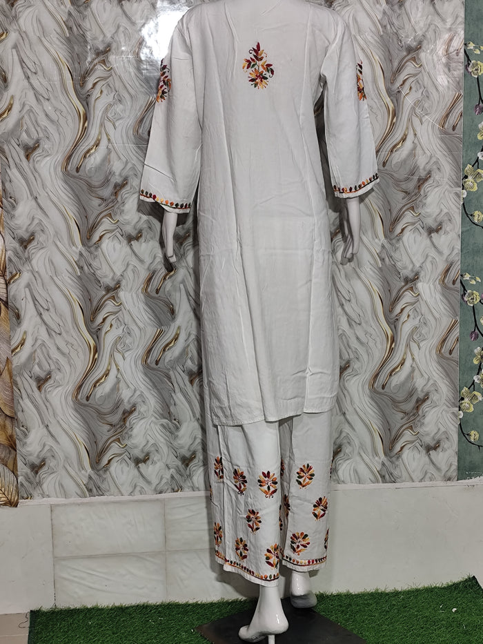 A vibrant Pristine White Rayon Kurta & Pant Set -multi-colour Lucknowi embroidery